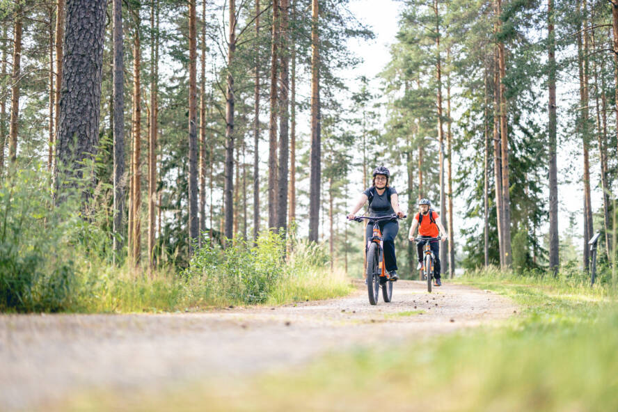 Kaksi pyöräilijää metsätiellä