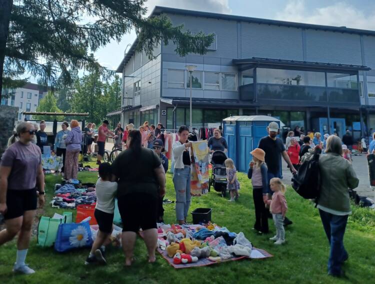 väkeä puistossa katselemassa kirpparitavaroita
