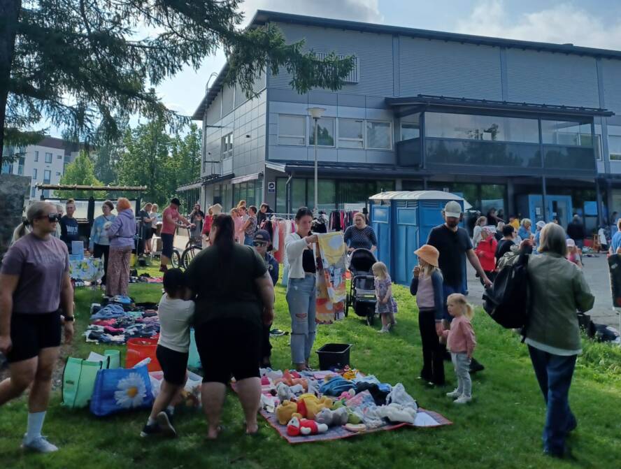 väkeä puistossa katselemassa kirpparitavaroita